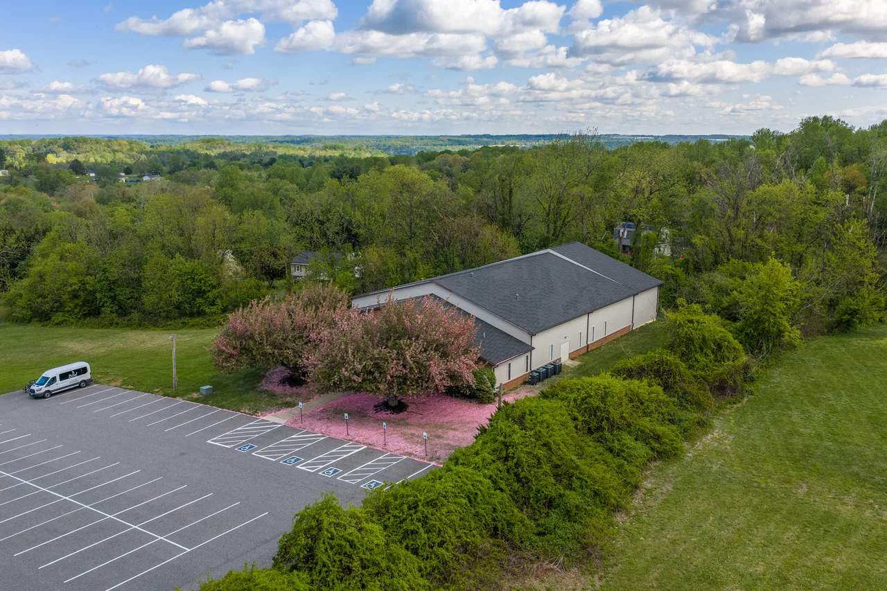 Bethel campus and front parking lot surrounded by trees