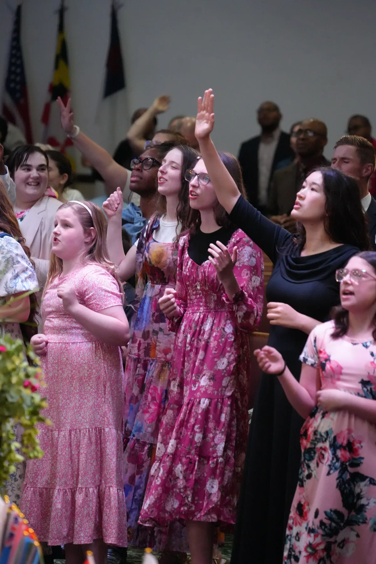 Members of Bethel worshipping together with hands raised